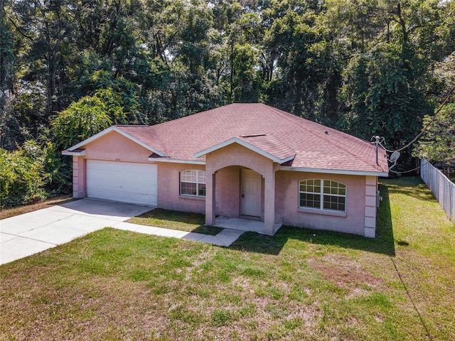 ranch-style home with a front yard and a garage