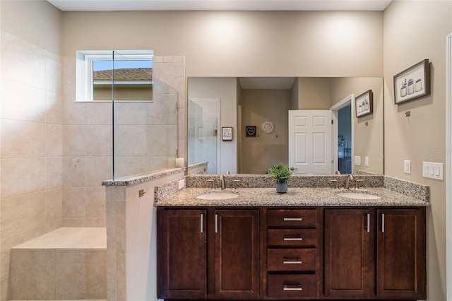 bathroom featuring vanity and tiled shower