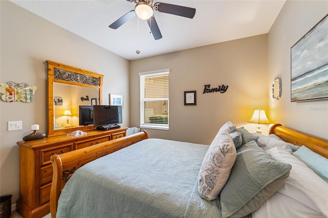 bedroom with a textured ceiling and ceiling fan