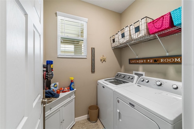 clothes washing area with cabinets, light tile patterned floors, and washer and dryer