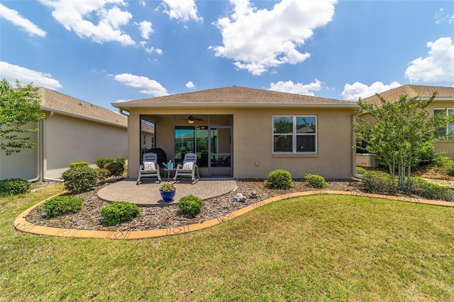 rear view of property with a yard, a patio, and ceiling fan