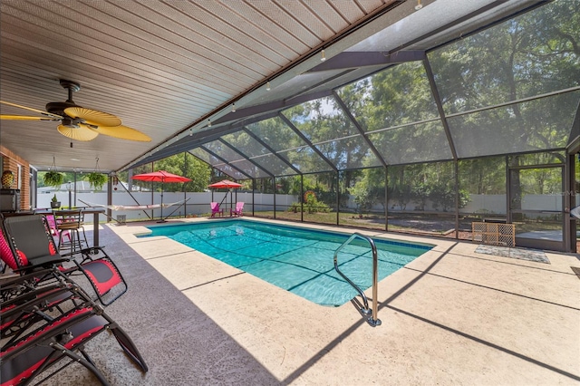 view of swimming pool featuring ceiling fan, a patio, and glass enclosure