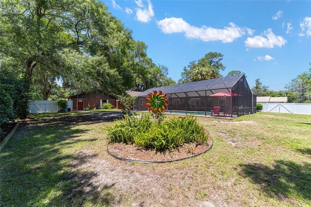 view of yard featuring a lanai and a fenced in pool