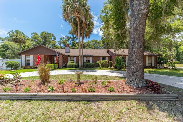 ranch-style home with a front lawn