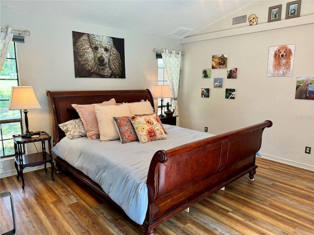 bedroom featuring lofted ceiling and hardwood / wood-style floors