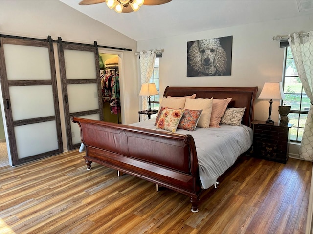 bedroom featuring wood-type flooring, a closet, ceiling fan, and a spacious closet