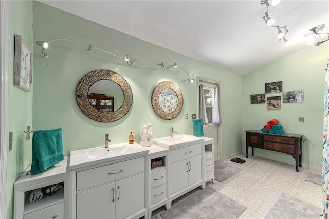 bathroom featuring vaulted ceiling, tile patterned floors, and vanity