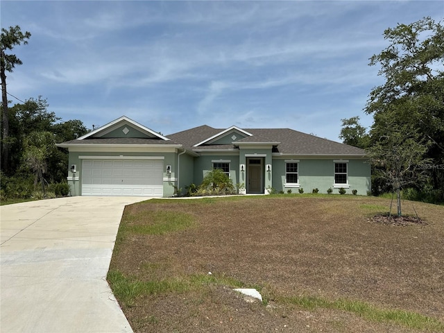 single story home with a garage and a front lawn