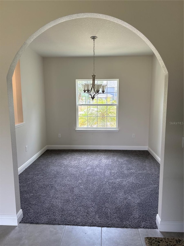 empty room with an inviting chandelier