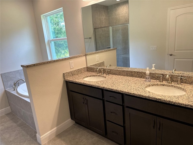 bathroom featuring tile patterned flooring, vanity, and shower with separate bathtub