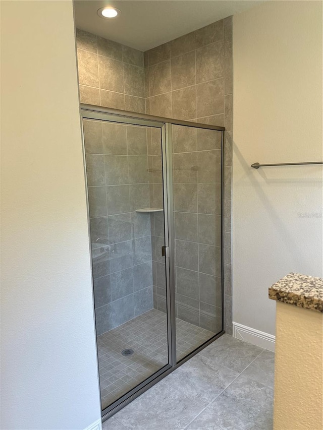 bathroom featuring tile patterned floors and a shower with door