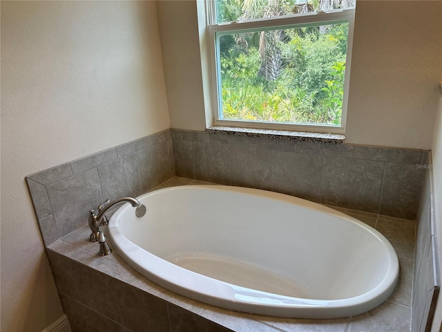 bathroom featuring a relaxing tiled tub