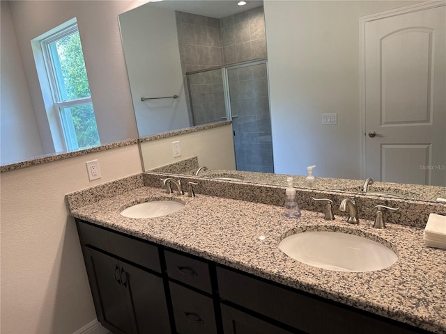 bathroom featuring vanity and a shower with door