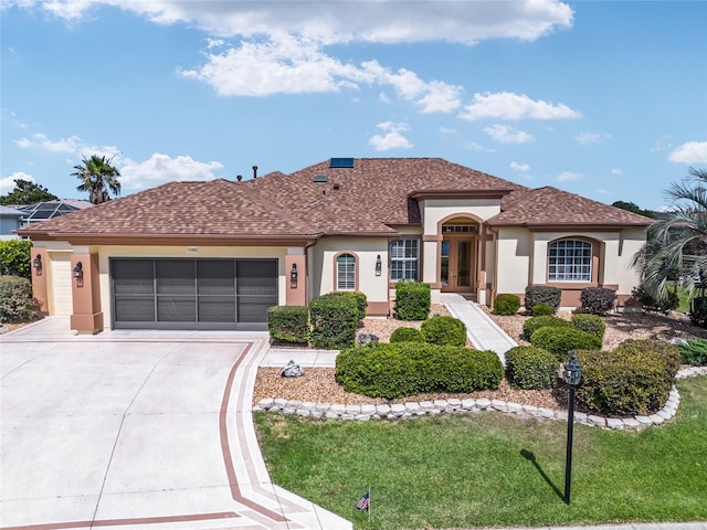 view of front facade with a front lawn and a garage