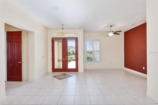 tiled foyer featuring ceiling fan and french doors