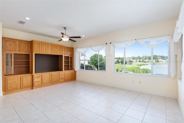 unfurnished living room with ceiling fan and light tile patterned flooring