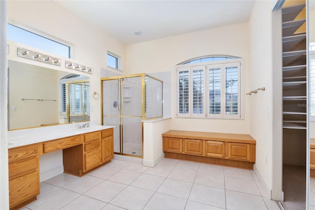 bathroom featuring tile patterned floors, a healthy amount of sunlight, and an enclosed shower