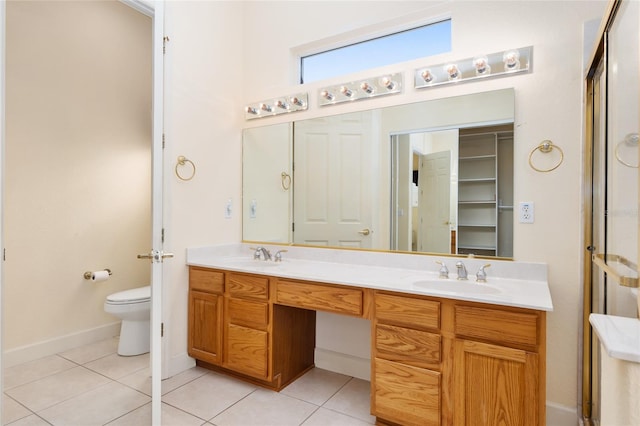 bathroom featuring tile patterned flooring, vanity, and toilet