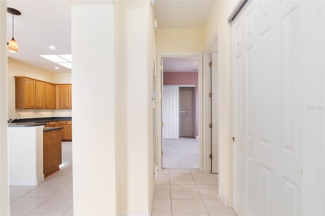 corridor featuring light tile patterned floors