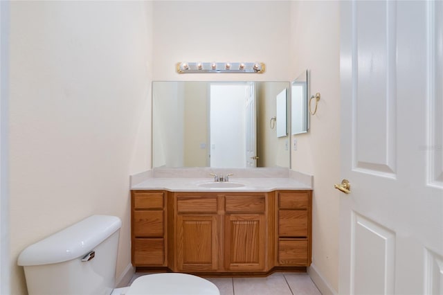 bathroom with tile patterned flooring, vanity, and toilet