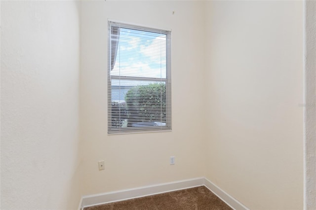 empty room featuring dark colored carpet