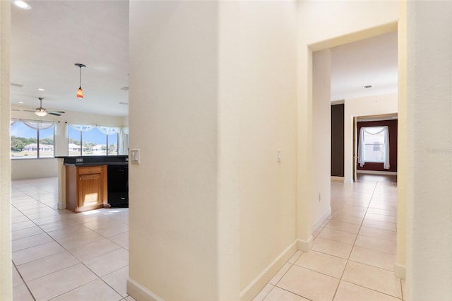 hall with light tile patterned floors