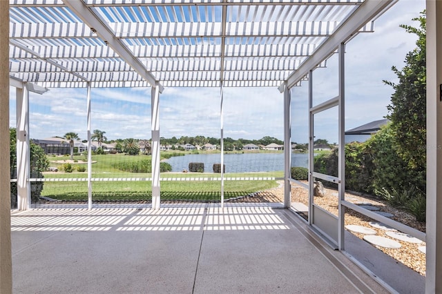 unfurnished sunroom featuring plenty of natural light and a water view