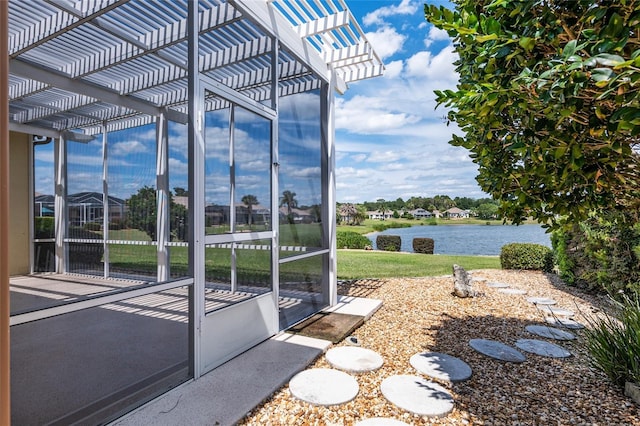 view of patio with a water view and a pergola