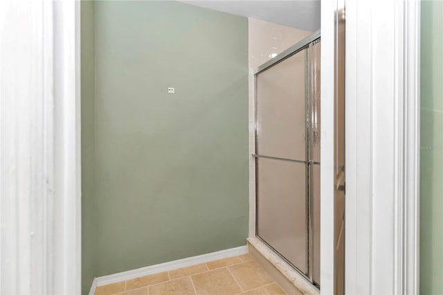 bathroom featuring tile patterned flooring and an enclosed shower