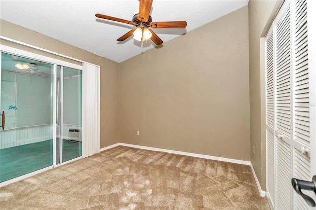 interior space with carpet, a wall mounted AC, and ceiling fan