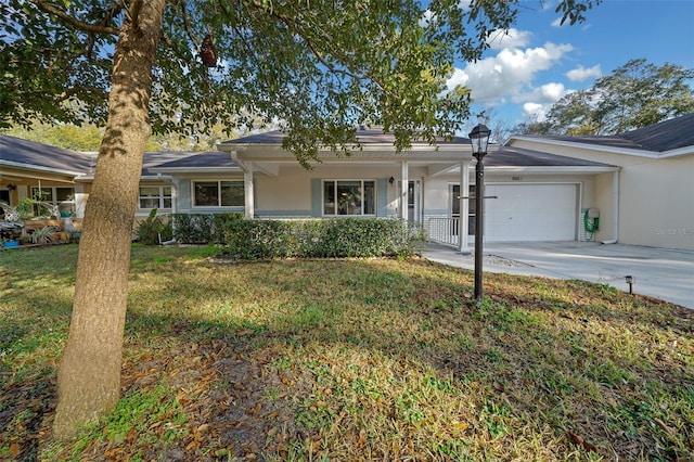 ranch-style house featuring driveway, stucco siding, an attached garage, covered porch, and a front yard