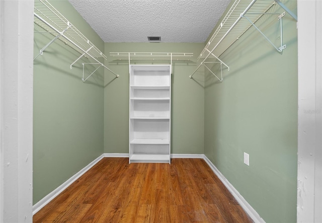 spacious closet with wood finished floors and visible vents