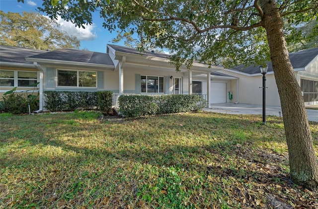 ranch-style house with an attached garage, driveway, a front yard, and stucco siding