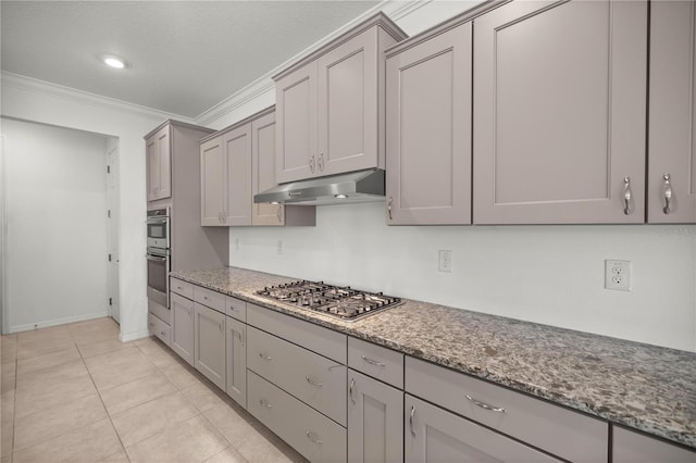 kitchen featuring appliances with stainless steel finishes, a textured ceiling, crown molding, light tile patterned floors, and stone countertops