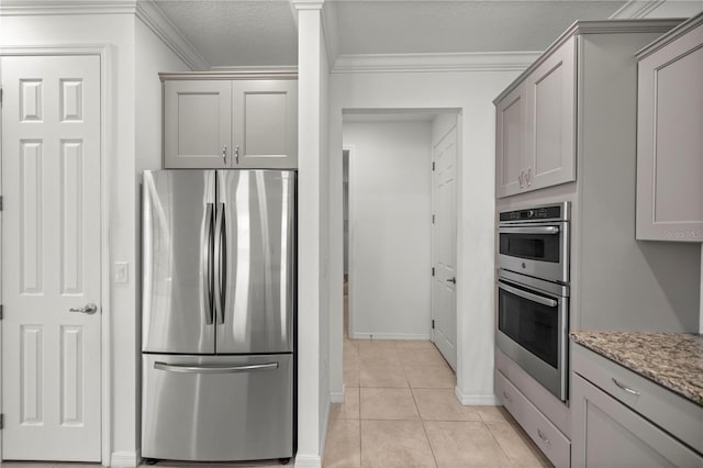 kitchen featuring gray cabinets, light tile patterned flooring, stainless steel appliances, and ornamental molding