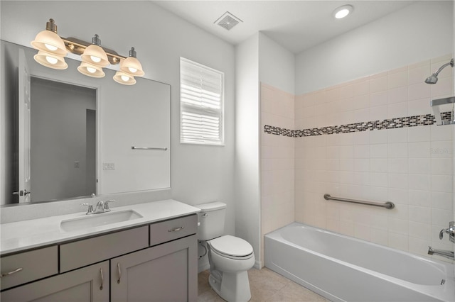 full bathroom with tile patterned flooring, vanity, toilet, and tiled shower / bath combo