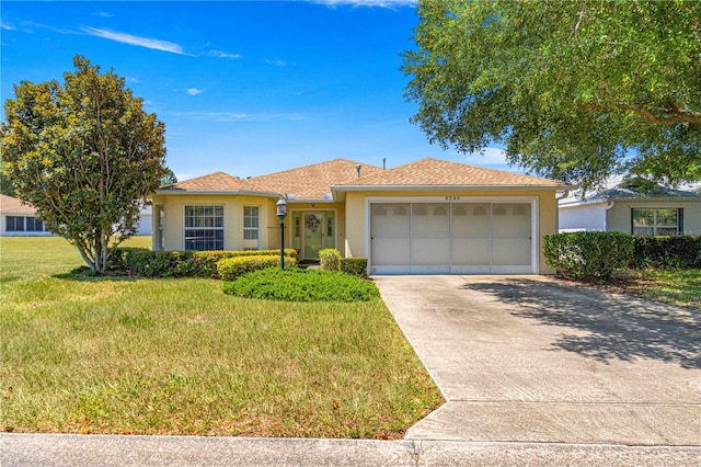 ranch-style home featuring a garage and a front yard