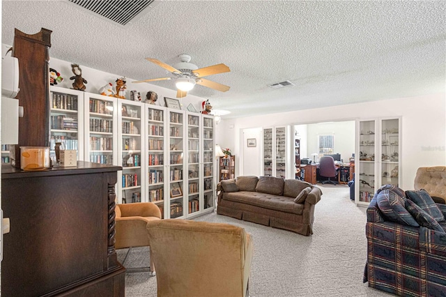 living room with carpet, a textured ceiling, and ceiling fan