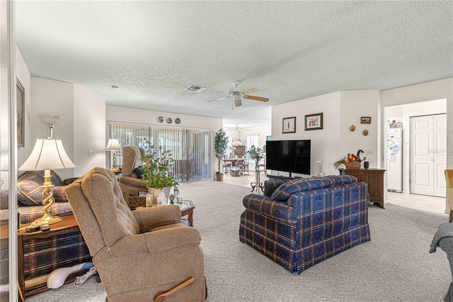 carpeted living room featuring a textured ceiling and ceiling fan