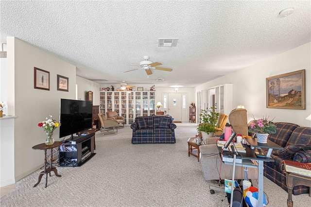 carpeted living room featuring a textured ceiling