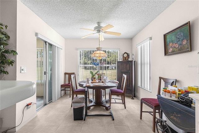 dining room with ceiling fan and a textured ceiling