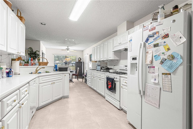 kitchen featuring white cabinetry, sink, white appliances, and a textured ceiling