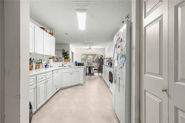 kitchen featuring kitchen peninsula, white cabinetry, dishwasher, and sink