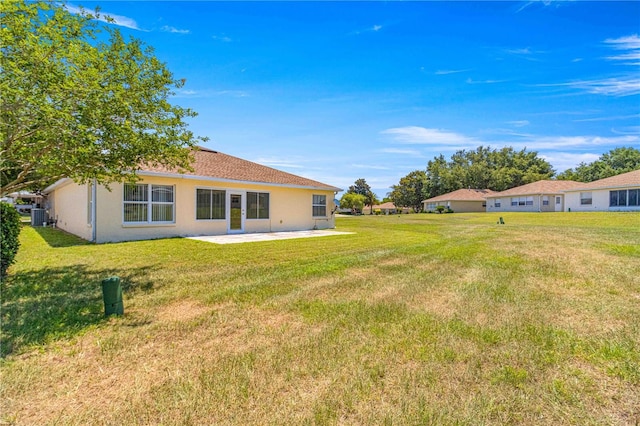 view of yard featuring a patio and central AC