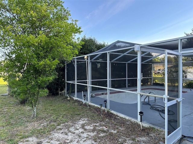 exterior space featuring a patio and glass enclosure