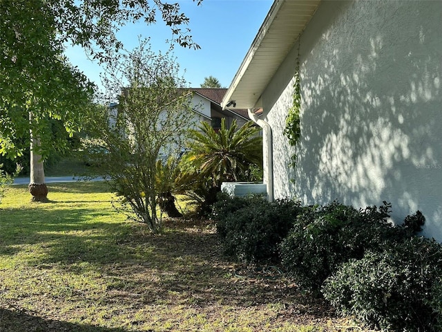 3817 SW 161st Loop, Ocala, FL 34473 - view of property exterior featuring stucco siding and a yard