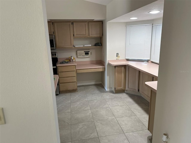 kitchen with built in desk and light tile flooring