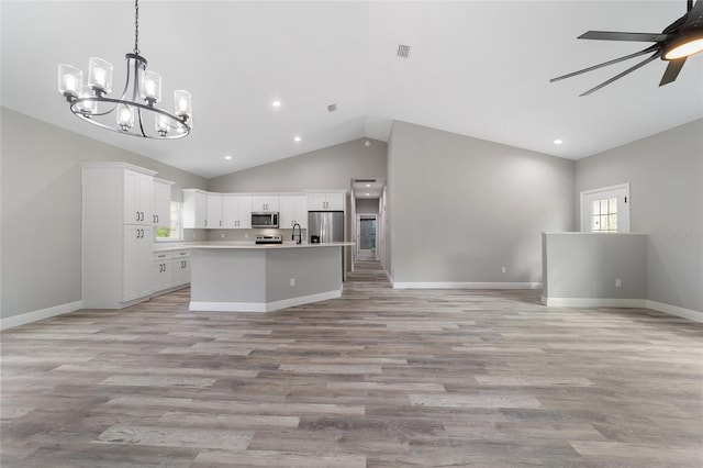 kitchen with stainless steel appliances, white cabinetry, an island with sink, light hardwood / wood-style flooring, and pendant lighting