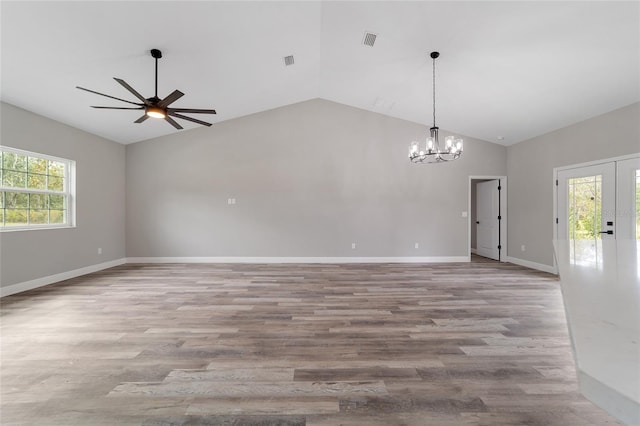 unfurnished room with light hardwood / wood-style flooring, lofted ceiling, and plenty of natural light