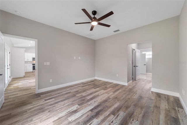 unfurnished room featuring hardwood / wood-style flooring and ceiling fan